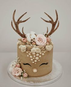 a cake with flowers and antlers on top