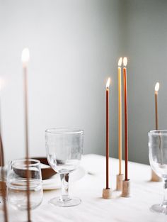 a table with candles and dishes on it