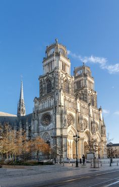 a large cathedral with many spires on the front and side of it's building