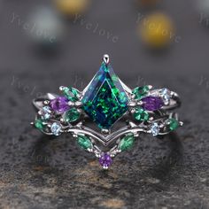 a ring with green and purple stones on it