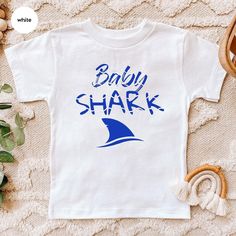 Baby Shark Shirt, Birthday Shark 2 Two Two Shirt, Happy Birthday Tee, Family Shark Birthday, Custom Baby Shark Birthday Tee, Do Do Do Hello, dear parents and little ones! We understand how important it is to dress your child in outfits that are both adorable and comfortable. Our baby bodysuits, youth, and toddler apparel are designed with soft, breathable fabrics to ensure all-day comfort, whether it's playtime or nap time. Our matching sets come in vibrant colors and feature unique designs, perfect for everyday adventures or family photos. Whether you're shopping for your own little one or searching for a thoughtful gift for a special occasion, our outfits are sure to bring joy to both parents and kids. We prioritize quality and convenience, with features that make diaper changes and outf Baby Shark Shirt, Baby Shark Birthday, Two Two, Dear Parents, Shark Shirt, Shark Birthday, Everyday Adventures, Birthday Tee, Baby Shark