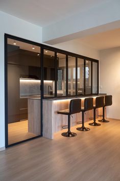 an empty kitchen and dining area with stools