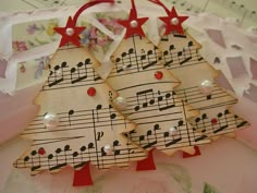 three decorated christmas trees with musical notes on them