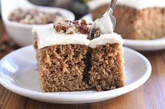 a piece of cake with white frosting and nuts on top is being eaten by a fork