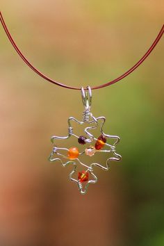 "~ This maple leaf is wire wrapped in sterling silver filled. This nature necklace can be adorned with small beads of amber, red garnet and orange jade, and peach and fire opal Swarovski crystals, according to availability. ~ The leaf pendant is mounted on an 18\" high quality colored wire necklace (orange and brick red, black, or silver, according to availability at time of order) and finished with a sterling silver lobster clasp. You can also choose a sterling silver chain in 16\" or 18\". ~ C Maple Leaf Necklace, Necklace Orange, Nature Necklace, Swarovski Crystal Necklace, Wire Necklace, Leaf Necklace, Leaf Pendant, Wire Earrings, Nature Jewelry