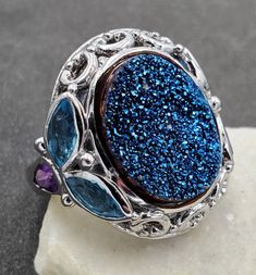 Lovely Estate, Signed RSI, 18x14mm Oval Blue Glitter Druzy, Amethyst and Blue Topaz 925 Sterling Silver Ring. This beautiful ring is sure to receive many compliments! SOLID925 STERLING SILVER, FULLY TESTED, NOT PLATED OR FILLED. Ring Size: 9.5 Width: 26mm - 3mm  Gemstone: Blue Druzy Quartz / Amethyst / Blue Topaz Weight: 13.1 Grams Hallmarked: RSI / 925 / China We gladly combine shipping! Everything is packed with care to make sure it arrives safely. We only sell authentic items. If it is a name Blue Multi-stone Amethyst Ring As Gift, Blue Oval Amethyst Ring In Sterling Silver, Blue Amethyst Ring With Accent Stones In Sterling Silver, Blue Oval Amethyst Jewelry, Blue Amethyst Gemstone Ring Gift, Blue Amethyst Ring In Sterling Silver For Gift, Blue Oval Amethyst Ring For Gift, Blue Amethyst Jewelry With Accent Stones, Blue Amethyst Anniversary Ring