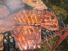 steaks are cooking on the grill outside