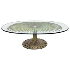 a glass table with an intricate design on the top and bottom, sitting in front of a white background