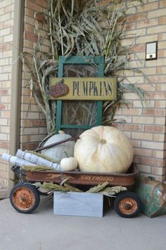 a pumpkin sitting on top of a wooden wagon