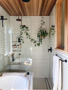 a white bath tub sitting under a wooden ceiling