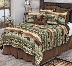 a bed with a brown and green comforter on it in a room next to a window