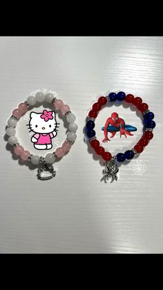 two bracelets with hello kitty charms on them