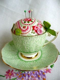 a green tea cup sitting on top of a saucer