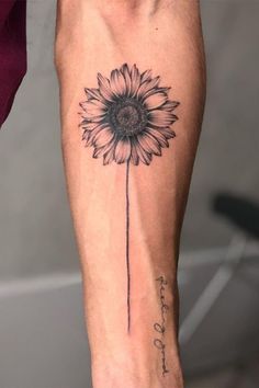 a person with a sunflower tattoo on their leg