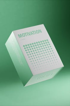 a white box with the word motivation printed on it, sitting in front of a green background