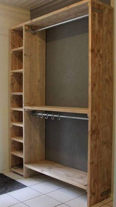 an empty closet with shelves and drawers in the middle of it, next to a tiled floor