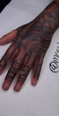 a person's hand with tattoos on it