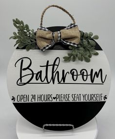 a bathroom sign with a bow on it