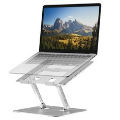 an open laptop computer sitting on top of a metal stand