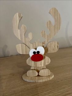 a wooden reindeer sitting on top of a table