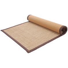 a rolled up mat on top of a roll of brown fabric with an area rug underneath it