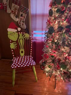 the grinch chair is next to the christmas tree