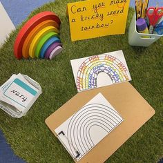 an assortment of arts and crafts are on the grass next to a sign that says can you make a lucky end rainbow?