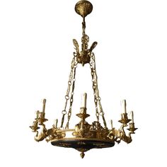 an antique chandelier with candles hanging from it