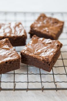 chocolate brownies with frosting on a cooling rack