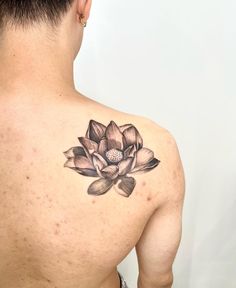 a man with a flower tattoo on his back