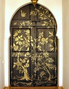 an ornate wooden door with flowers painted on it