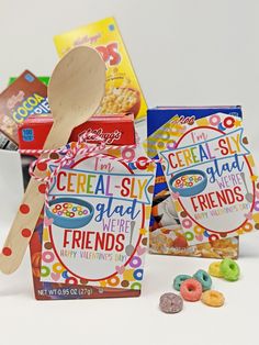 cereal box with wooden spoon next to it and two bags of cereal in the background