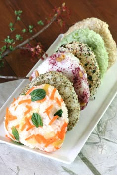 there are four different types of food on this white plate and one is green, orange, and pink