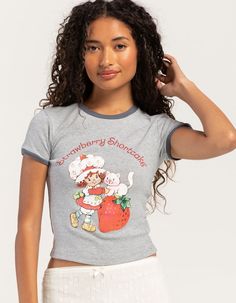 Strawberry Shortcake Ringer Tee. Rib Knit Construction. Large Graphic Screened On Front. Ribbed Crew Neckline. Short Sleeve. Contrast Trim. 60% Cotton, 40% Polyester. Machine Wash. Imported.officially Licensed Model Is Wearing A Size Small. Model Measurements:height: 5'6" Bust: 30"waist: 25.5"hips: 36.5" Strawberry Shortcake Shirt, Flannel Sweatshirt, Graphic Trends, Kids Graphic Tees, Ringer Tee, Open Knit Sweater, Cargo Skirt, Boy Tees, Top Graphic Tees