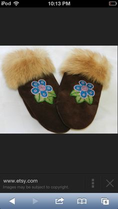 a pair of brown slippers with blue flowers on the bottom and fur trimmings