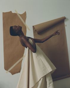 a woman standing in front of a piece of artwork