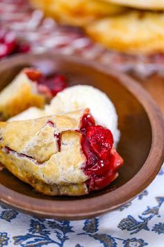 there is a small piece of pie on the plate with ice cream and raspberry sauce