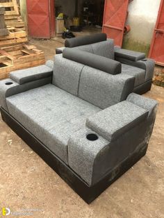 three grey couches sitting on top of each other in front of some pallets