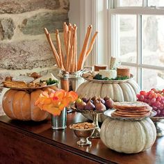 a table topped with lots of food next to a window