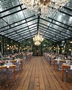 an indoor dining area with tables, chairs and chandeliers