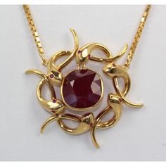 This is part of Chairish’s Fine Jewelry assortment.  METAL: 18k yellow gold, 22k chain WEIGHT: 26.3 grams STONES: Ruby, 9 cts. CONDITION: Excellent, vintage  Retro Snake Wreath Pendant African Ruby. This amazingly unique pendant is a circle wreath made out of 14k yellow gold snakes with ruby eyes (not tested). In the center swings a 9+ carat natural African ruby, which is just a gorgeous shade of ruby red. The wreath hangs from a 22k gold neck chain. This Retro piece was once a pin and is now a Snake Wreath, 22k Gold Chain, Gold Neck Chain, Circle Wreath, Hanging Wreath, Ruby Necklace, Neck Chain, Gold Snake, Unique Pendant