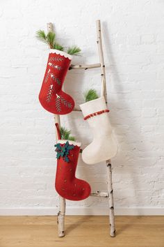 an old ladder is decorated with christmas stockings