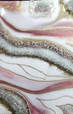 an abstract glass plate with silver, pink and white designs