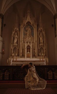 a woman is standing in front of the alter