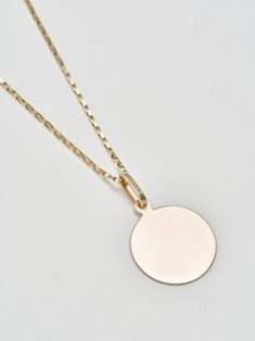 Sentimental? Same. The Disk Pendant handcrafted in L.A. from 14Kt gold is the perfect piece to engrave with a memorable message.  Make it even more personal by stringing it from a chain of your choice. The durable, heavyweight medallion will become your everyday heirloom.14Kt Yellow Gold Disk Pendant Width: 20mm Sold solo on 100% Silk Japanese Red CordPictured with Petite Industrial Box Link Chain and XL Lightweight Havana Chain Shop all chain optionsMade in L.A. Dainty Round Disc Coin Pendant Jewelry, Gold Disc Pendant, Gold Brass Round Disc Necklace, Gold-plated Round Disc Coin Necklace, Gold Tarnish-resistant Round Disc Necklaces, Gold Disc, Silk Cord, Disc Pendant, 14kt Gold