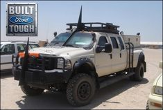 an off road vehicle parked in front of a sign for built to touch auto sales