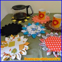 coffee mugs and paper flowers on a table