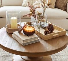 a coffee table topped with books and candles