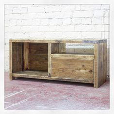 an entertainment center made out of pallets and wooden planks with one drawer open