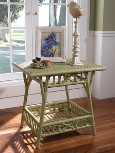 a green table with a basket on it in front of a window